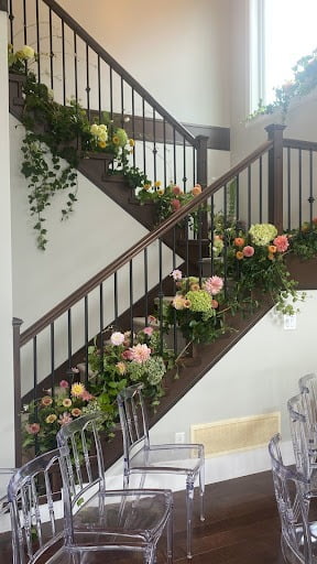 Flowers arrange down a staircase in wedding venue