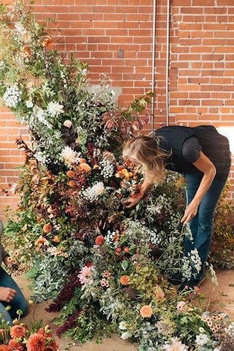 Floral Designer Lexi Richards creating an arch arrangement