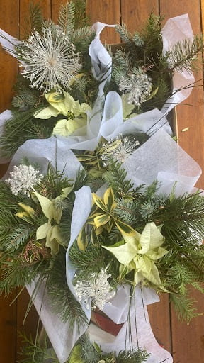 Winter bouquets with winter flowers: Pointsettia, dried alliums, euonymous and winter foliage.