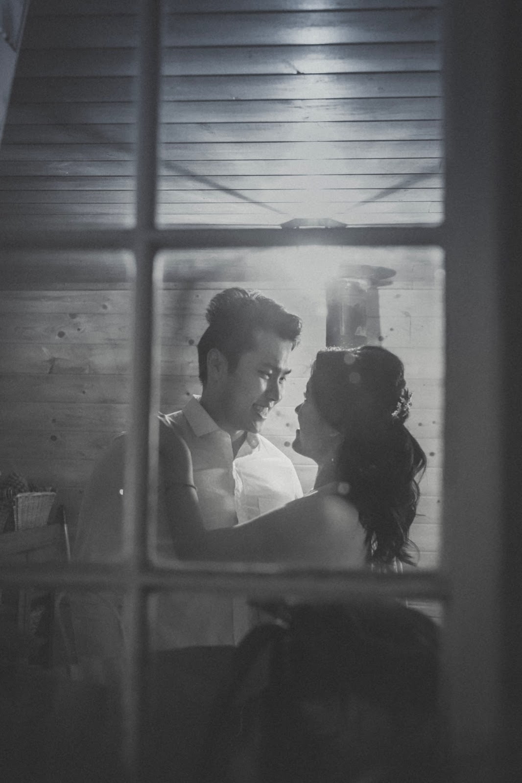 Dancing couple seen through a paned window