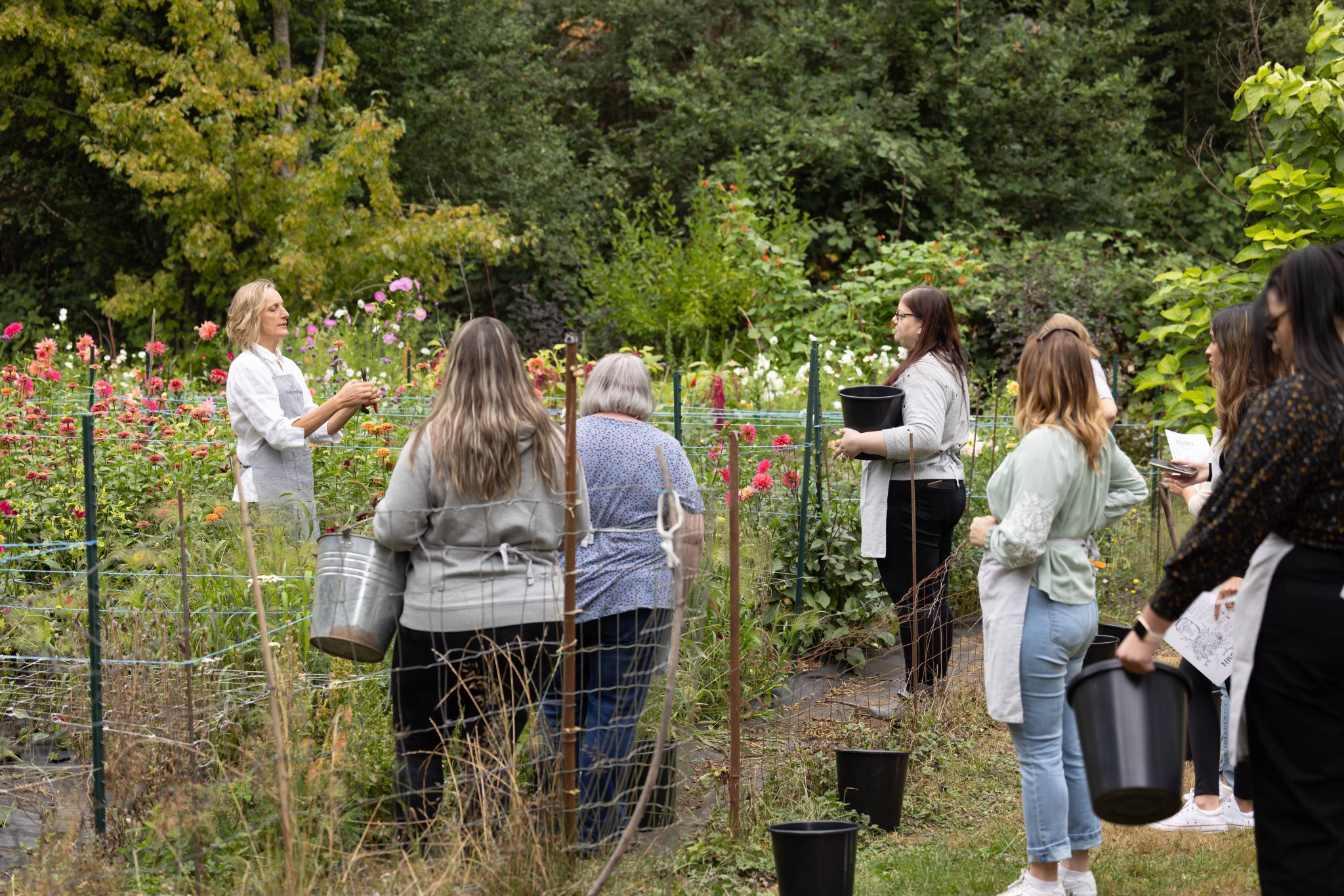 Workshop participants in the flower field with floral designer and instructor Lexi Richards.