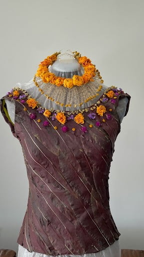 Dress Bodice made of flowers is displayed on a dress manikin.