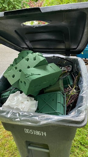 Discarded floral foam in garbage bins.