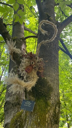 Monkey made from dried flowers 'climbs' a tree.
