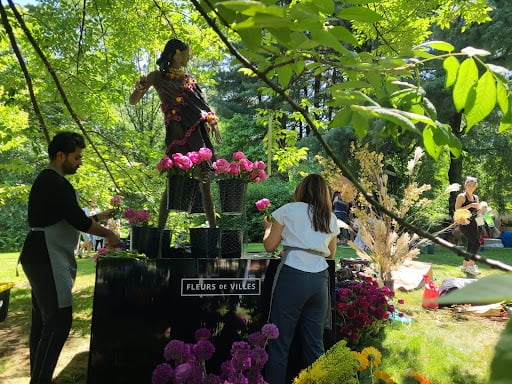 Three floral designers help set up the floral installation at Van Dusen Gardens.
