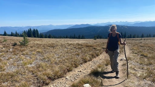 Floral Designer, Lexi Richards, pauses on a hiking trail in Manning Park