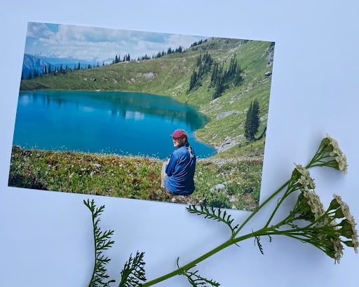 Photograph of a young woman near an alpine lake